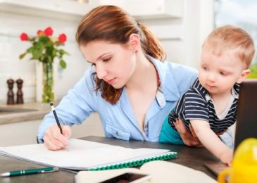 young-mother-studying-at-home-with-baby